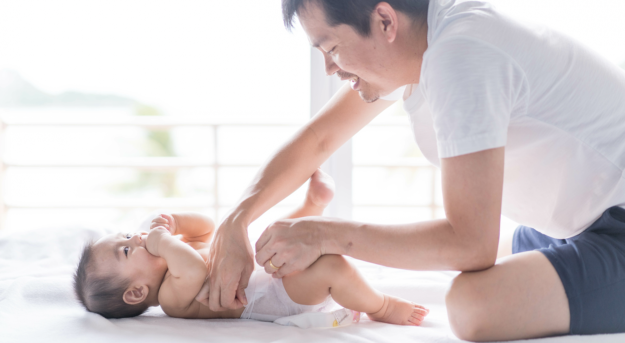 Father changing diaper.