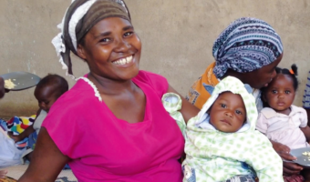 Ugandan mother carrying her baby